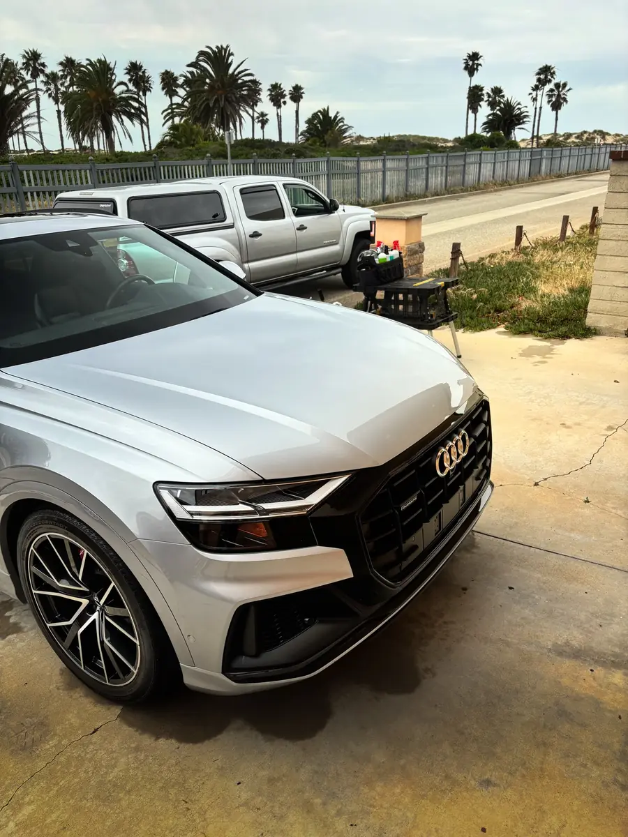 White Audi Q8 detailed by the coast