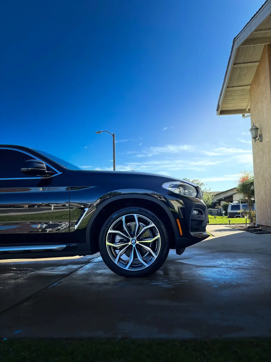 Dark blue BMW X3 in the sun after a full detail
