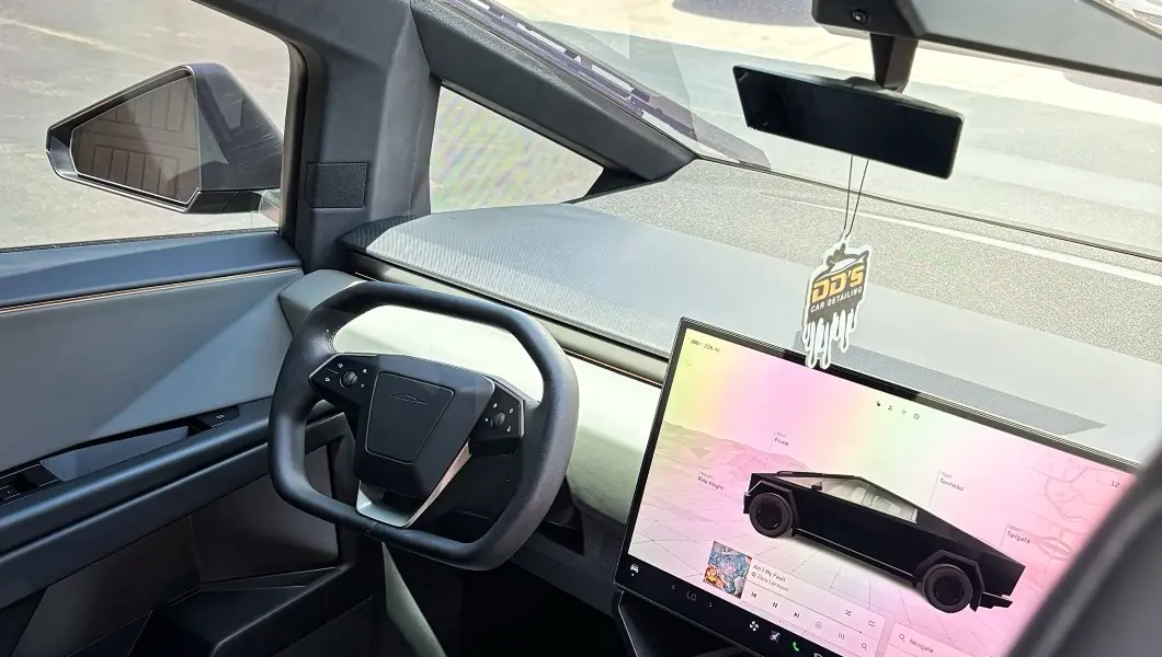 Spotless Cybertruck cockpit with DD's air freshener on the mirror