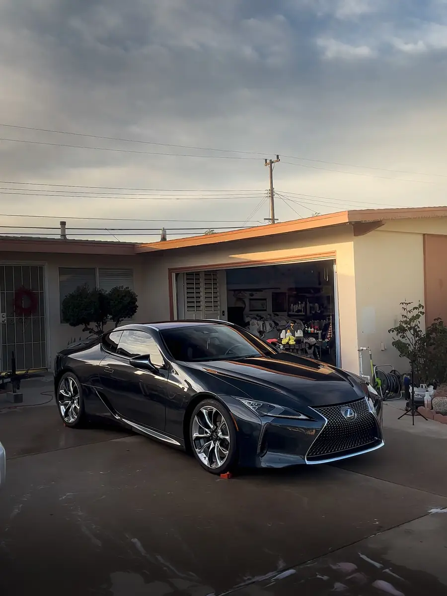 Lexus LC 500 grand tourer gleaming in a driveway