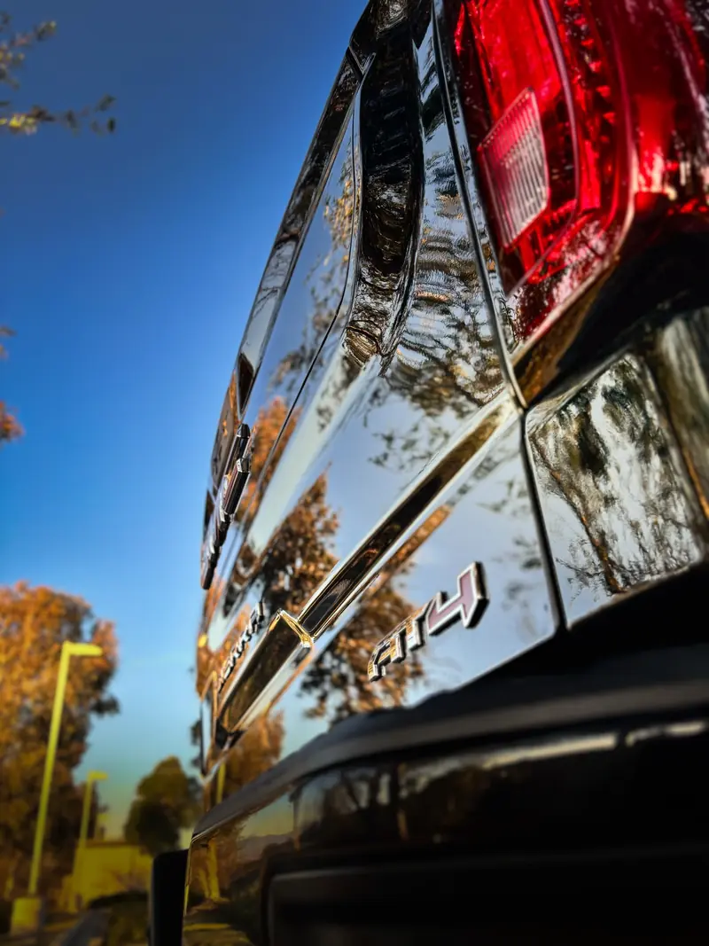Mirror-like reflections in the corrected black paint of a GMC pickup