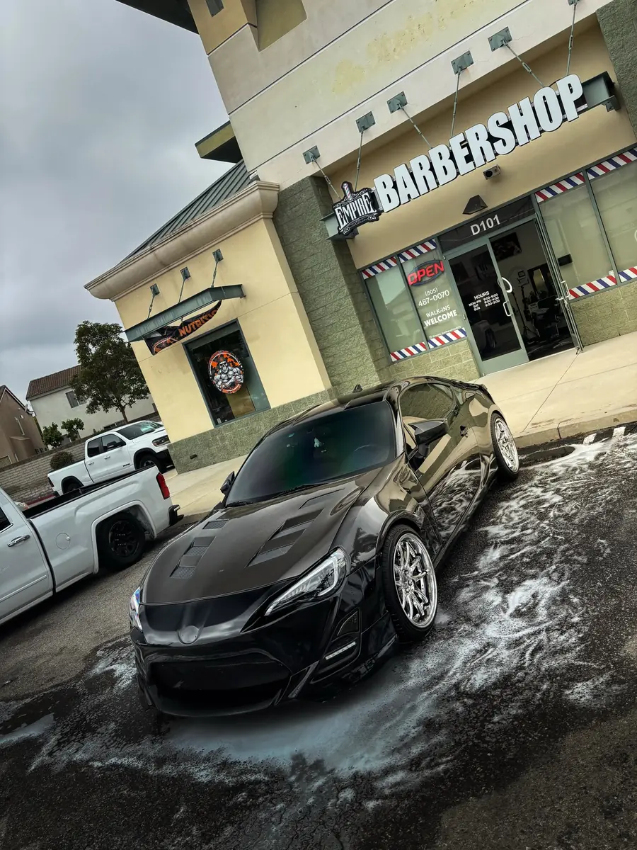 Black Toyota 86 detailed outside a local barbershop